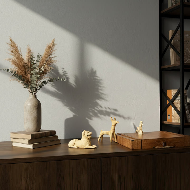 Ancient Animal Guardian Set displayed on a wooden table in a boho-style interior — four handmade animal totem sculptures arranged with warm lighting, symbolizing harmony between nature and ancient civilizations.