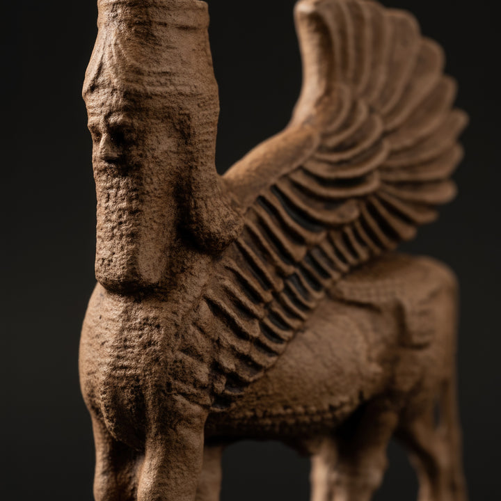 Koyu fonda dramatik ışıkla vurgulanan Asur Lamassu heykeli – koruma sembolü olarak zarafet ve gücü bir araya getirir. / Assyrian Lamassu statue on dark background – illuminated with artistic lighting to emphasize divine power and protection symbolism, museum art photography.