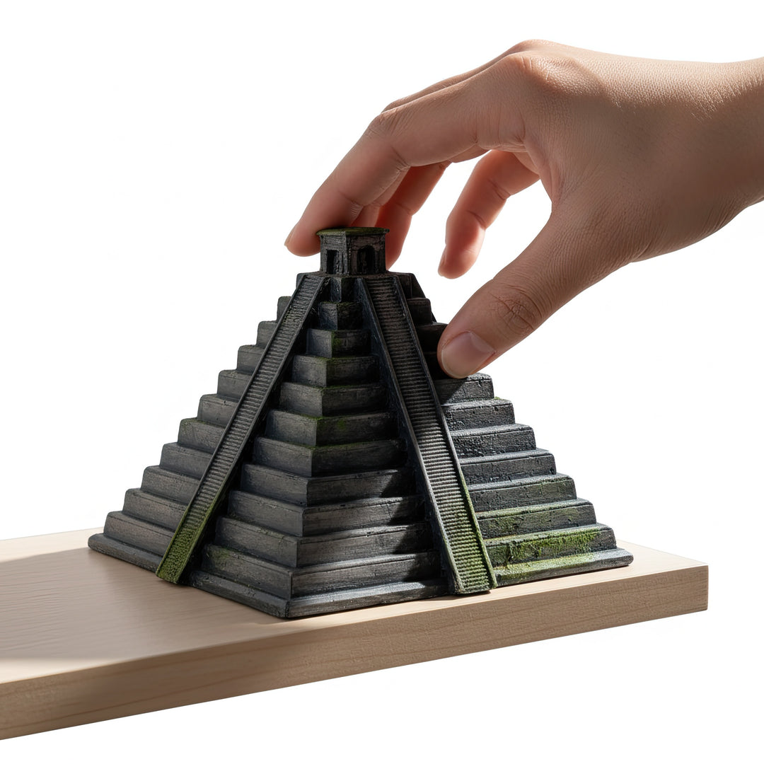 “Hand placing the handmade Chichen Itza Pyramid replica on a wooden shelf — a detailed archaeological decor piece reflecting ancient Mayan craftsmanship and sacred temple design.”
TR:
“Elin, el yapımı Chichen Itza Piramidi replikasını ahşap bir rafa yerleştirdiği görsel — antik Maya el işçiliğini ve kutsal tapınak mimarisini yansıtan detaylı bir arkeolojik dekor objesi.”