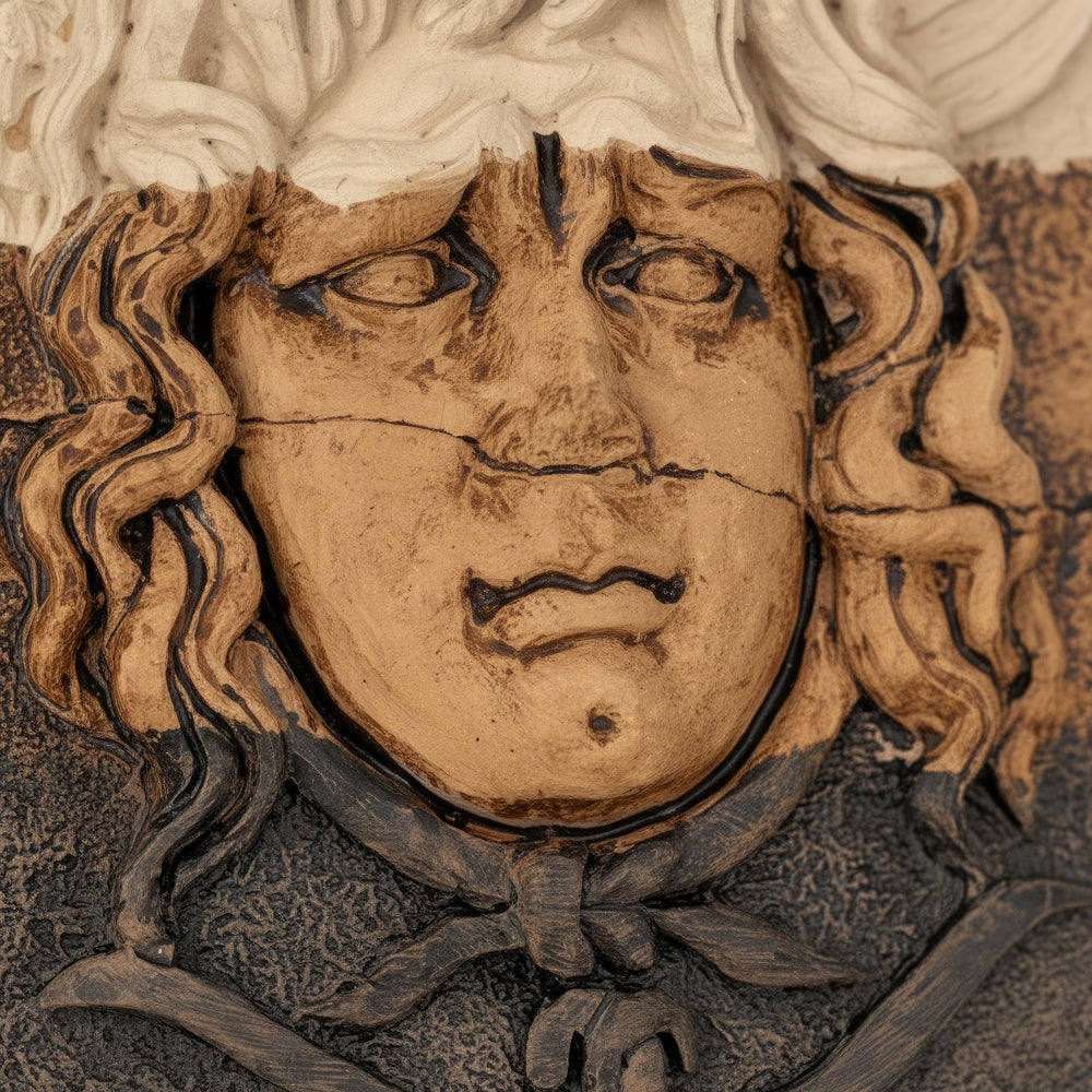 “Macro close-up of Medusa’s sculpted face revealing intricate hand-carved texture, natural clay patina, and ancient-style shading. This fine detail highlights the craftsmanship and timeless artistry of the handmade Greek mythology relief.”
TR:
“Medusa’nın oyulmuş yüzünü gösteren makro yakın plan detay — el işçiliğiyle şekillendirilmiş dokular, doğal kil patinası ve antik tarz gölgelendirmeler öne çıkıyor. Bu detay, el yapımı Yunan mitolojisi rölyefinin zamansız sanatını vurgular.”