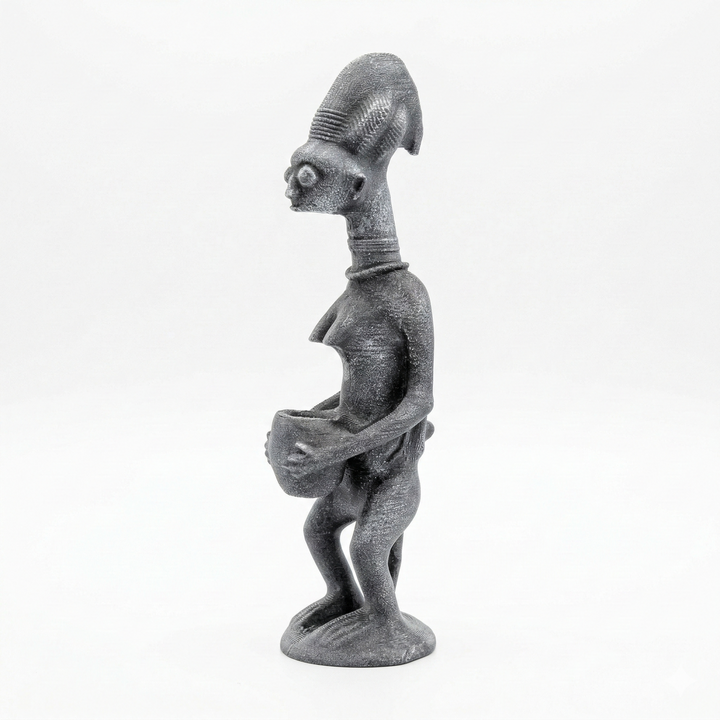 Yoruba mother and child heykeli taş ton yan açı, Afrika tribal sanatına ait sırtında çocuk taşıyan kadın figürü ve ritüel sunu kasesi ile kültürel ve spiritüel anlam taşıyan dekoratif obje by ArkeoArt